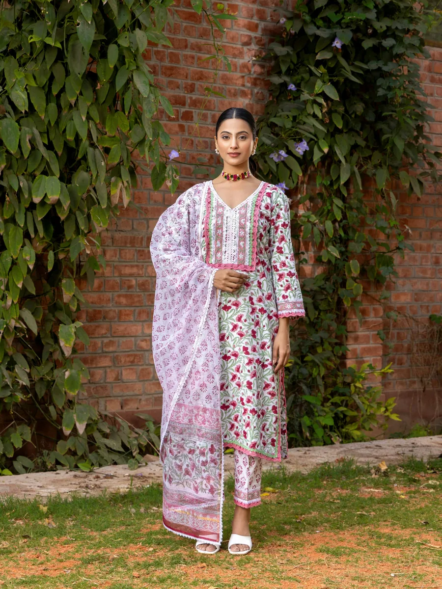 Woman modelling a floral Indian suit with a dupatta